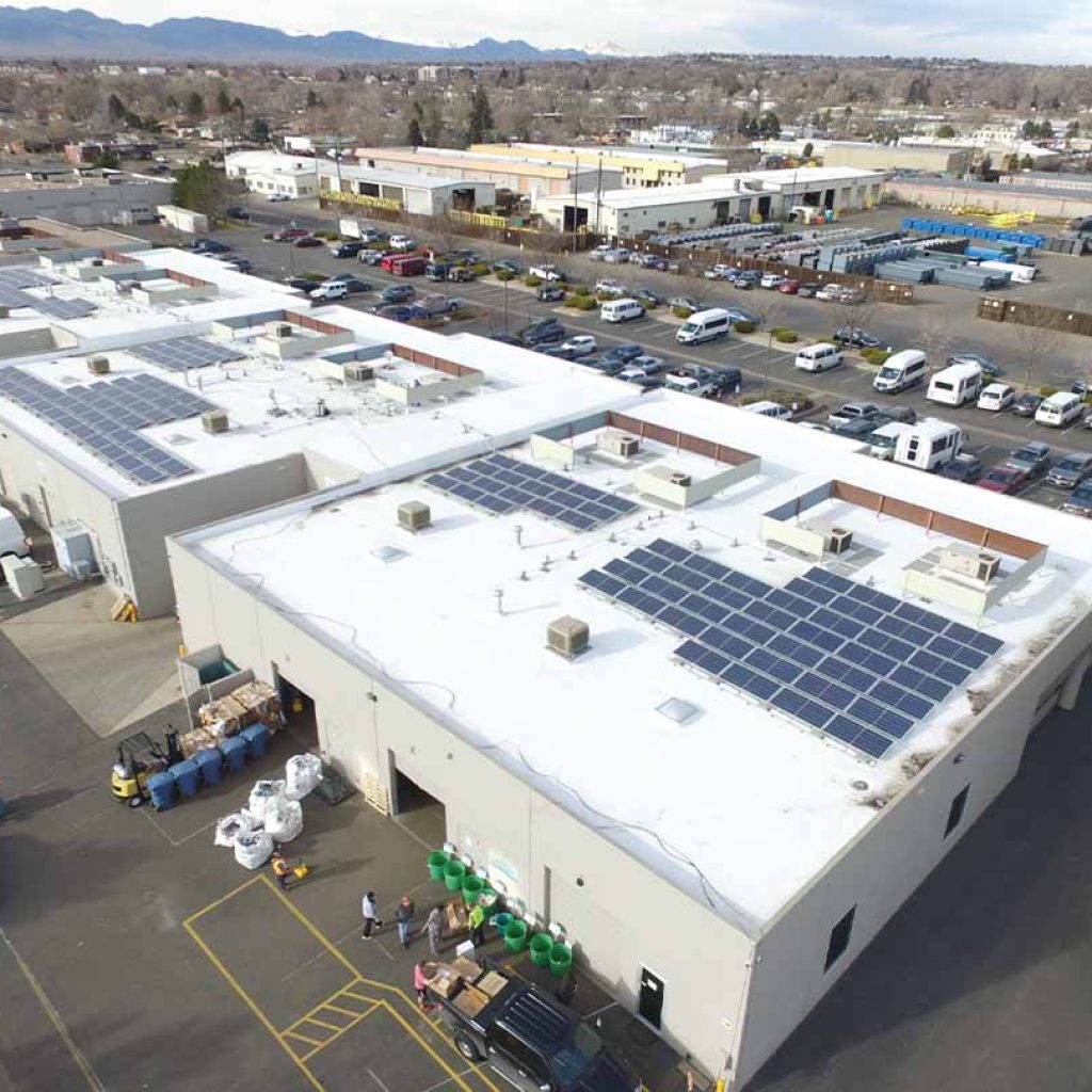 A large commercial building featuring a prominent white roof, showcasing modern architectural design and ample space.